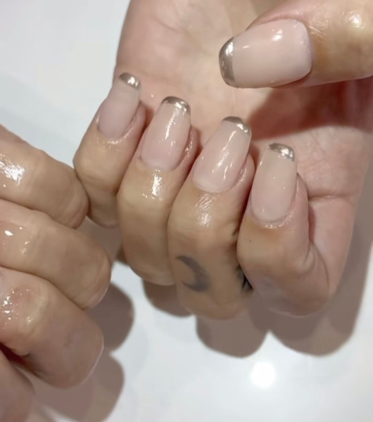 Demi Lovato's hands wearing a micro straight French manicure with silver tips