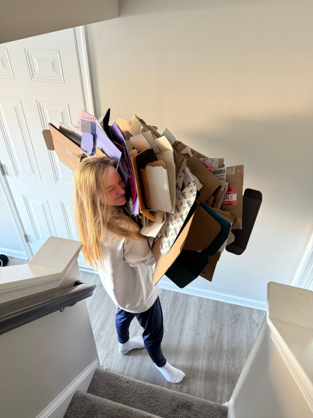 Senior director of audience development Lexi Herrick carries the aftermath of opening Best of Beauty packages out of her...