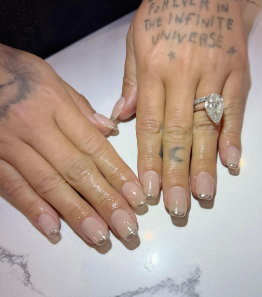Demi Lovato's hands wearing a micro straight French manicure with silver tips